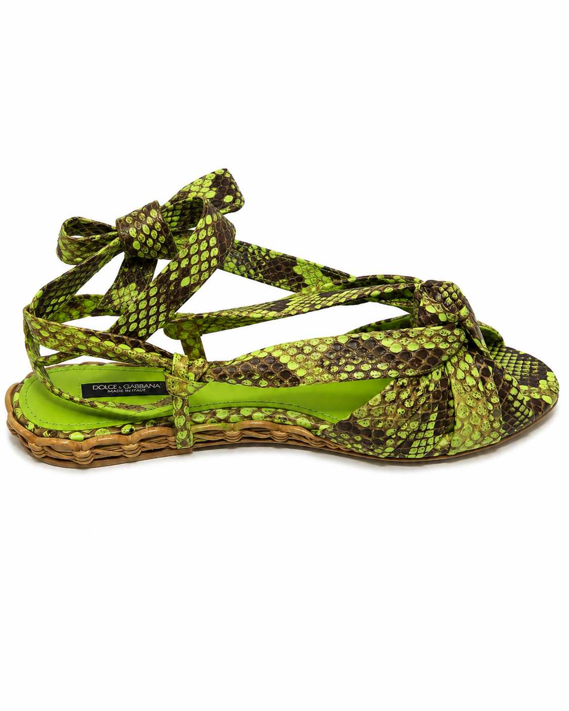 A single women's espadrille sandal with a green and brown snakeskin pattern upper, featuring a bright lime green insole and a woven jute platform sole, shown against a plain white background.