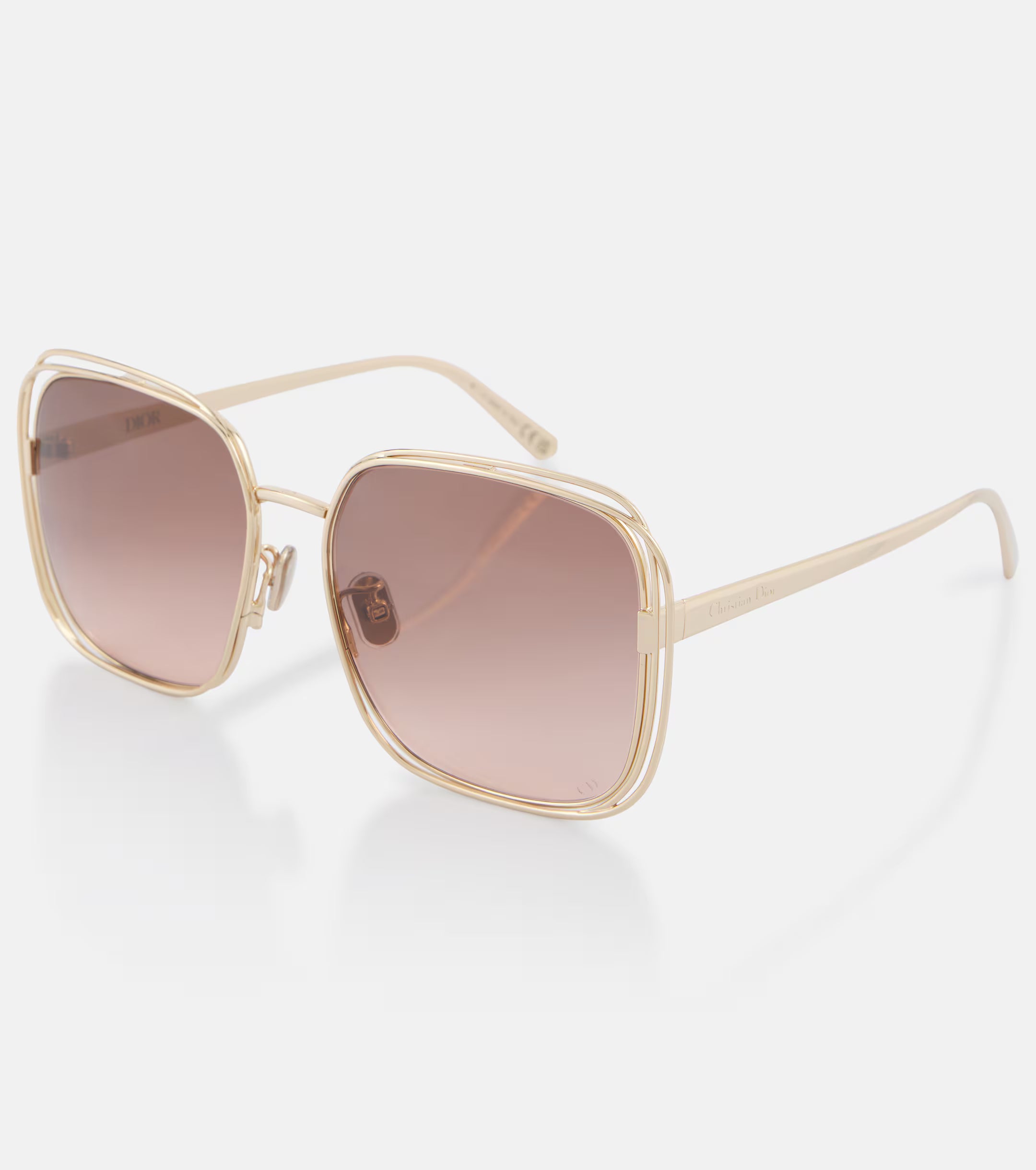 Gold-framed sunglasses with brown gradient lenses on a white background