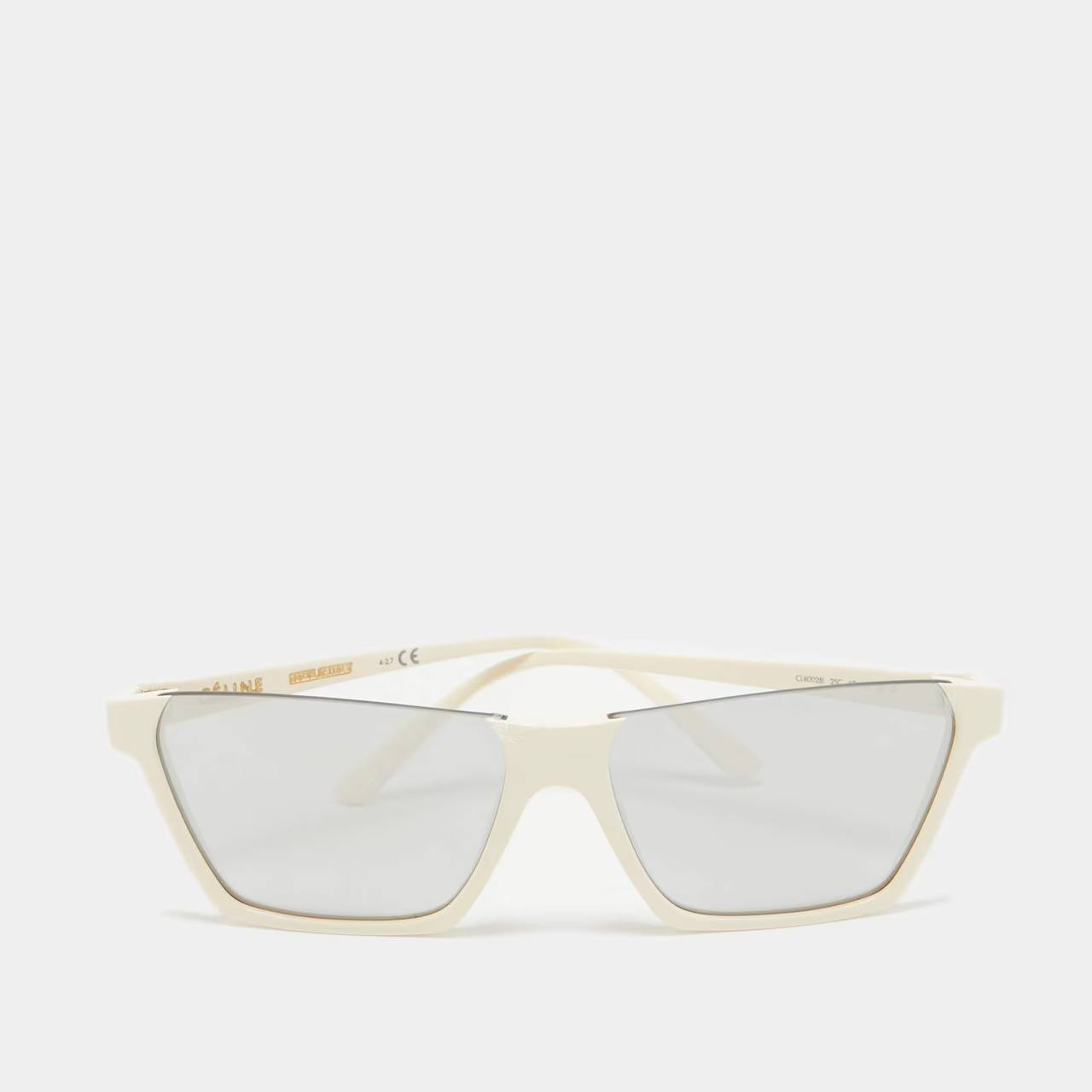 A pair of oversized square sunglasses with a thick cream-colored frame and clear lenses, shown against a light gray background.