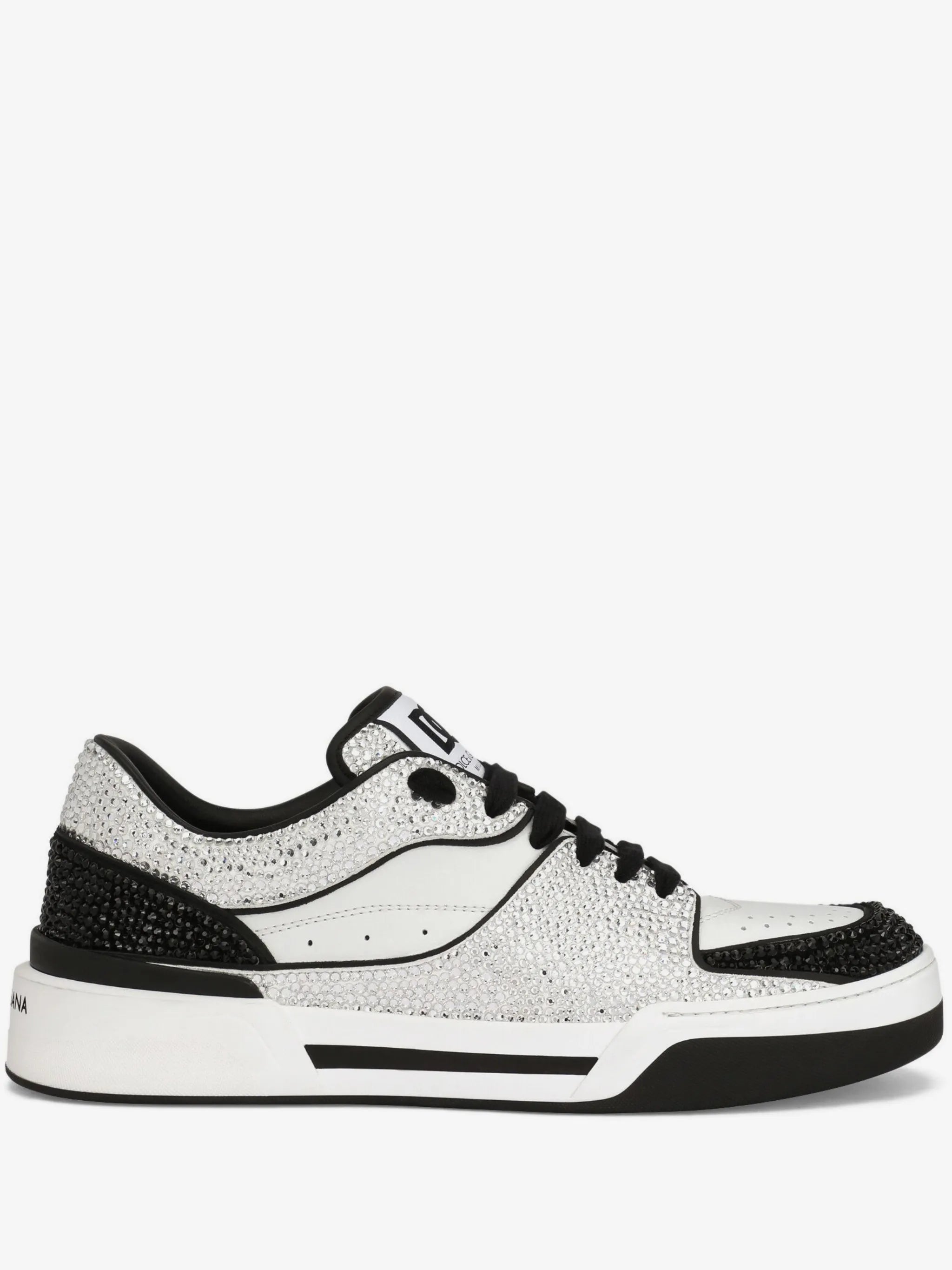 A low-top sneaker featuring a textured silver and black upper, black laces, a black heel section, and a thick white midsole with black detailing, set against a plain white background.