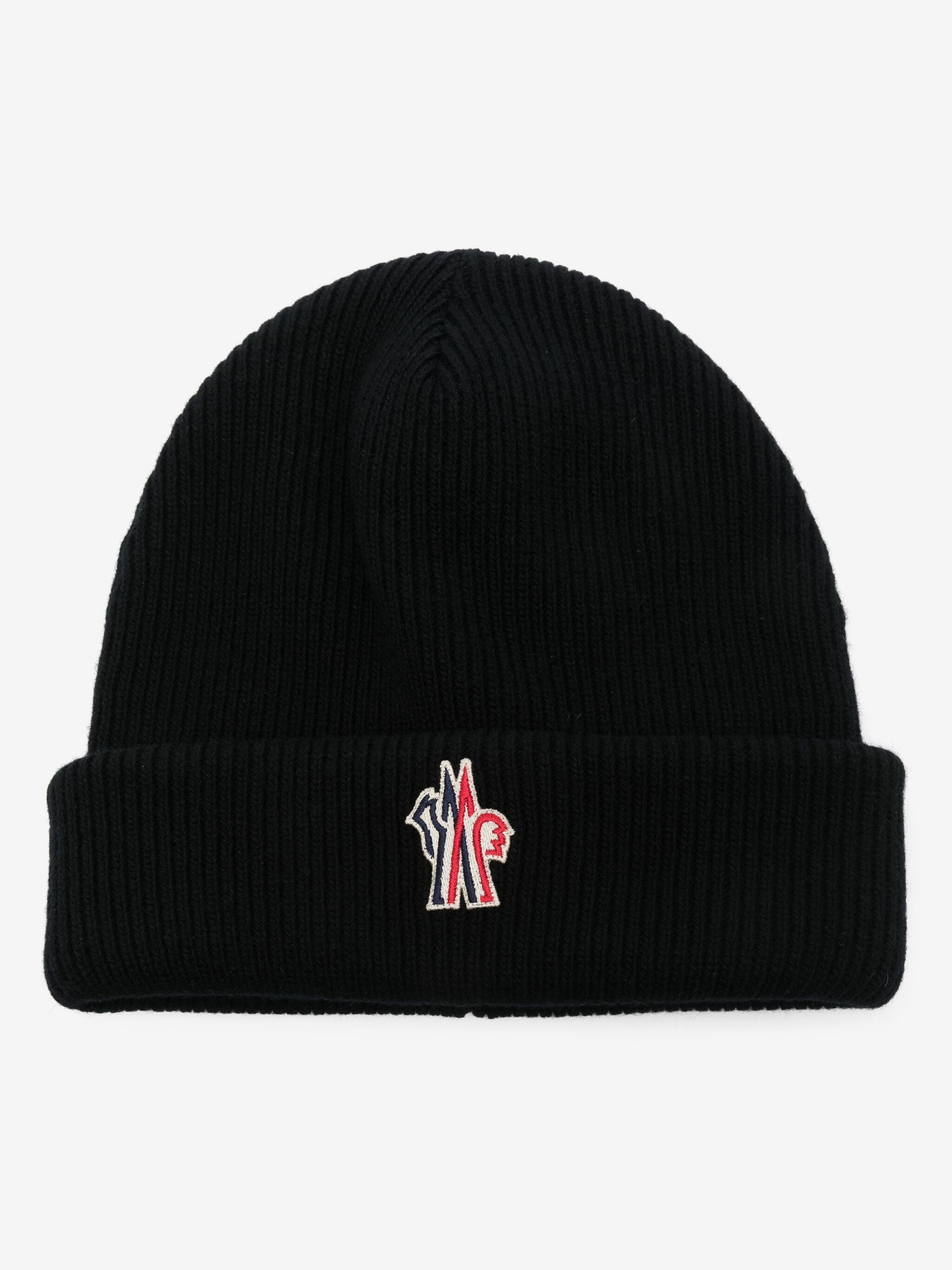 A black ribbed knit beanie hat with a folded cuff, featuring a small embroidered logo on the front in red, white, and black.