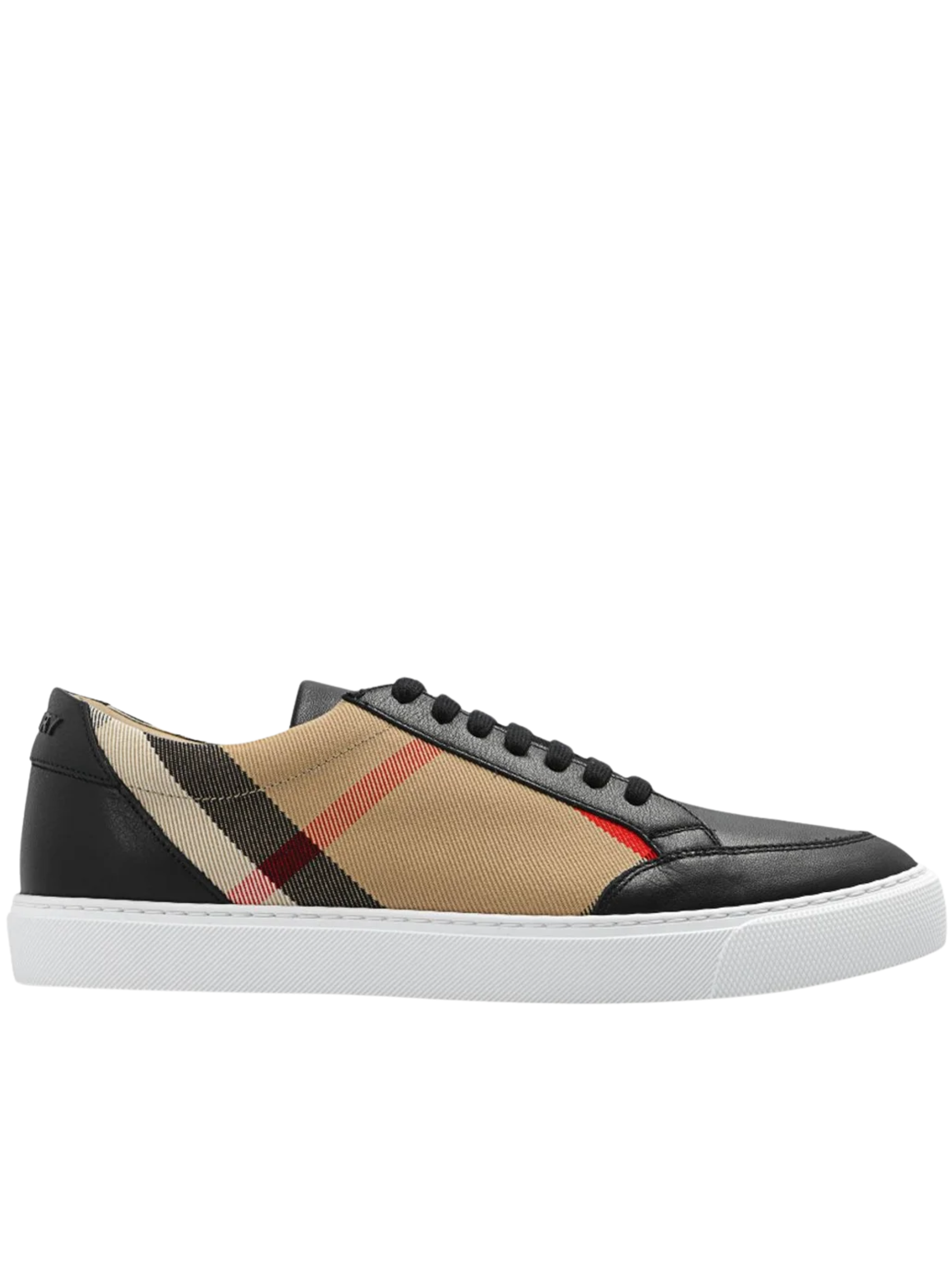 A low-top sneaker featuring black leather panels, a beige canvas body with the classic red, beige, and black plaid pattern, a red stripe accent, and a thick white rubber sole.
