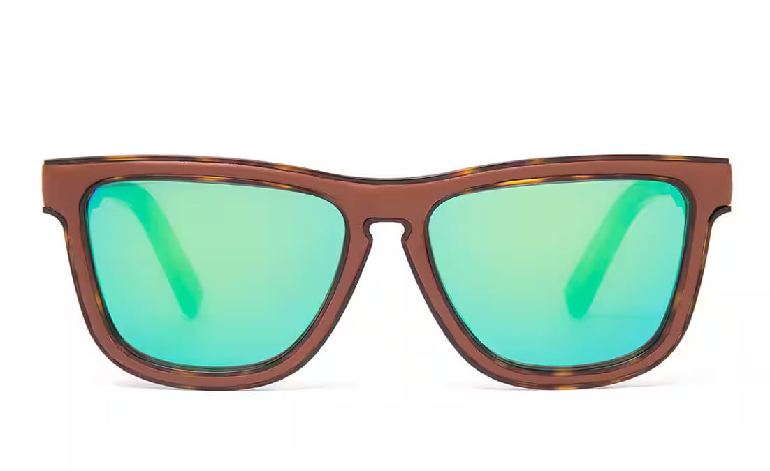 A pair of oversized square sunglasses with a translucent brown tortoiseshell frame and vibrant green mirrored lenses, shown against a plain white background.